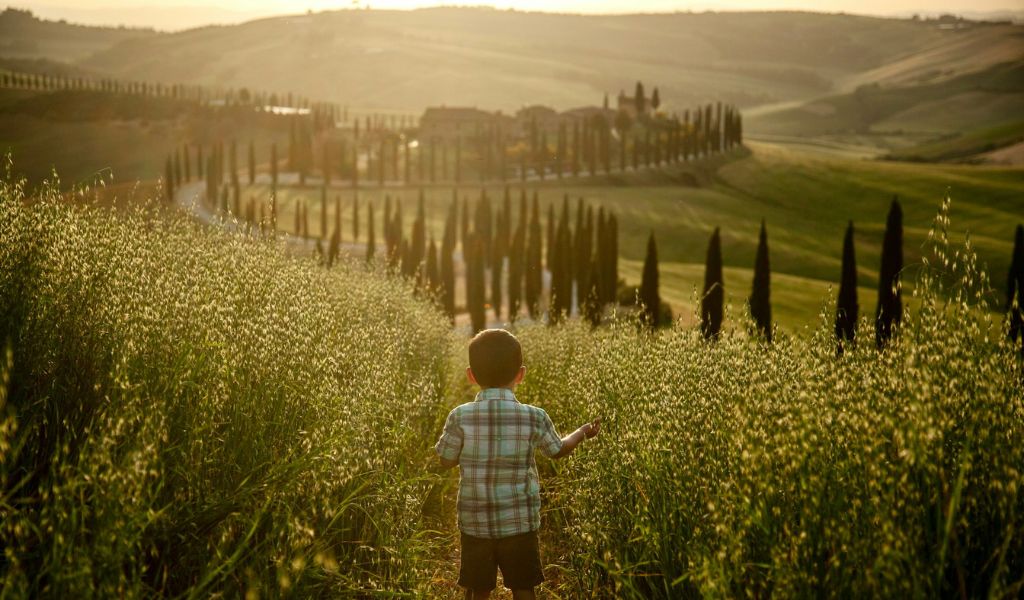 child in a field in the italian countryside
